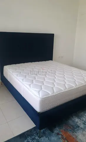 Queen bed frame with mattress - navy upholstered, good condition