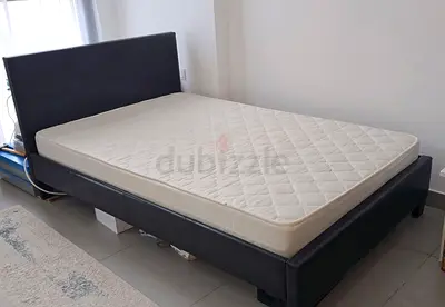 A single bed from Pan Emirate, made with dark brown faux leather, with a good‑quality mattress.