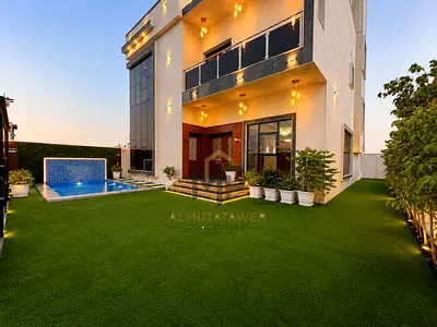 Luxury villa with swimming pool in Al Amerah area, Ajman. Price includes electricity, water, and air conditioning. Land area 4200 sq ft, built-up area