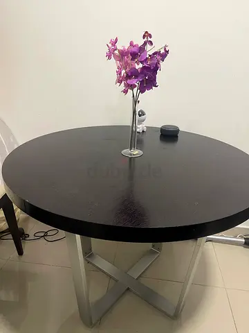 Round black dining table with metal base