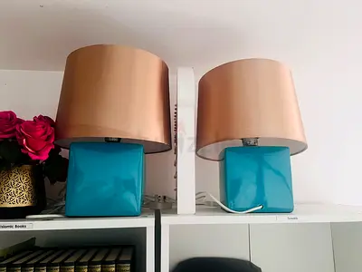 Pair of teal ceramic table lamps with beige shades