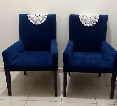 Pair of navy blue velvet dining chairs with armrests