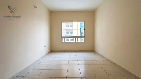 1BR apartment for annual rent on Sheikh Khalifa St., Al Nuaimiya 2, Ajman, opposite Gulf Bridge. Central AC, ideal location near all services.