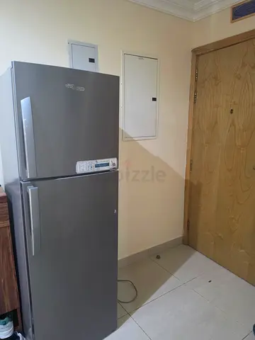 Silver double-door refrigerator with top freezer - good condition