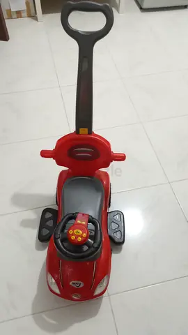 Red push ride-on car with parent handle - good condition. With parent handle, footboard, safety lock