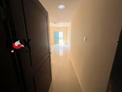 One-bedroom apartment with a living room for annual rent in Al Hamidiya, Ajman. Features a balcony and two bathrooms. Price: 30,000 AED