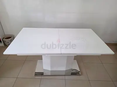 White modern extendable dining table with pedestal base