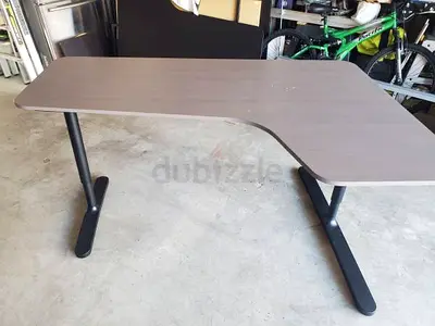 IKEA Bekant standing office desk with metal legs — grey wood finish