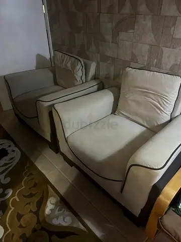 Cream fabric 2-seater sofa with dark wood trim — good condition. 100 each seat. Both 200 fixed