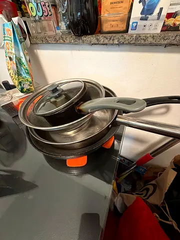 Used stainless steel pots and pans set with lids - good condition