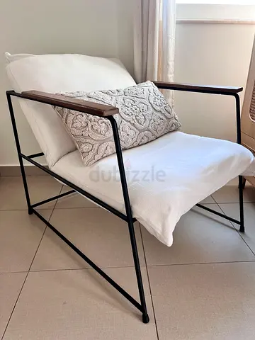 Modern minimalist black metal frame lounge chair with white cushion
