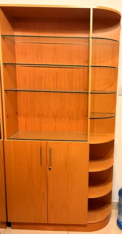 Wooden display cabinet with glass shelves and storage cupboard