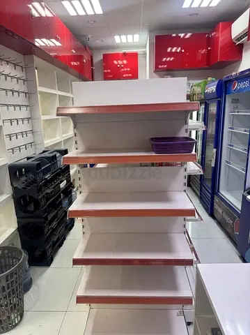 Double-sided retail shelving gondola unit with wooden trim — good condition