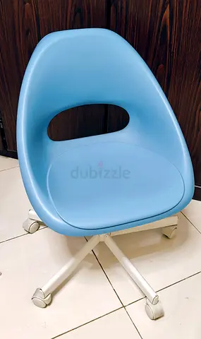 Light blue swivel office chair on wheels - compact ergonomic design