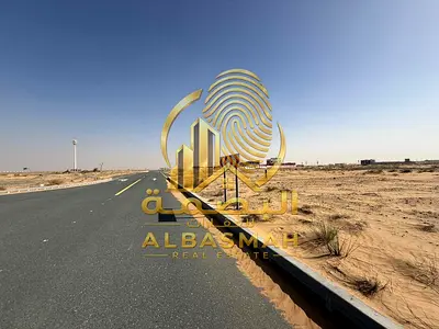 Residential land for sale in Sharjah, Rawdat Al Qurt area, second row from Street 97, freehold ownership for Arabs.