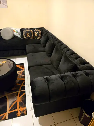 Large L-shaped black velvet sectional sofa — good condition with middle centre table