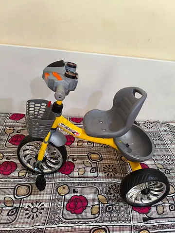 Yellow toddler tricycle with storage basket and rear tray - good condition