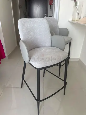Pair of modern grey upholstered dining chairs with metal legs