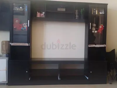 Dark wood entertainment center / TV unit with glass display cabinets