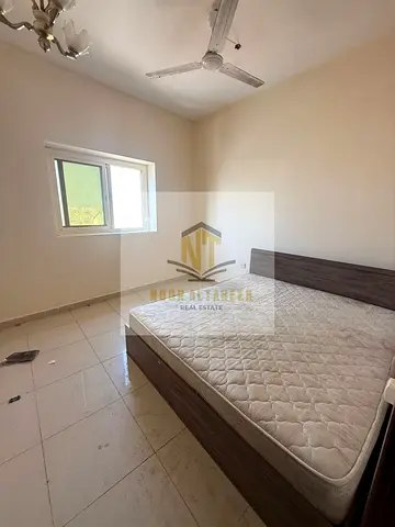 One-bedroom apartment with a living room for rent in the Emirate of Sharjah, specifically in the Al Butina area. The rental price is 26,000 UAE dirham