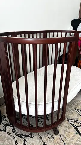 Stokke wooden baby crib / bassinet on wheels - dark brown.