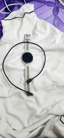 Used round smartwatch with charging cable - good working condition