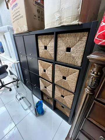 Black Storage Unit with Woven Baskets and Drawers