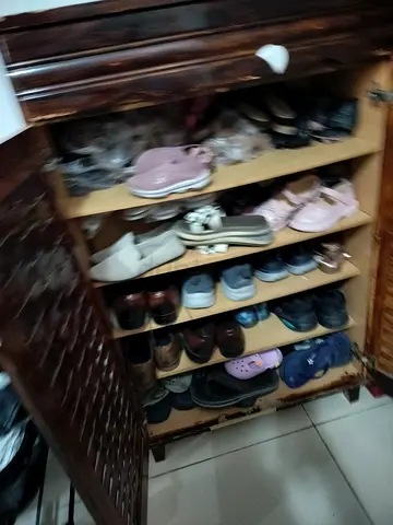 Wooden shoe cabinet with multiple pairs of shoes included
