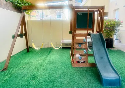 Wooden outdoor playset with slide and swings - good condition