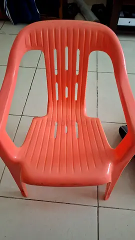 Used orange plastic outdoor/indoor chair - sturdy simple design