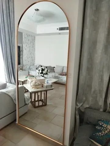 Large arched floor mirror with gold frame