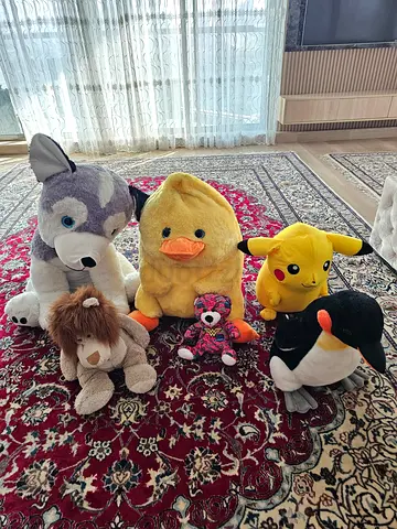 Assorted plush toys collection — Pikachu, duck, wolf, lion, penguin + small bear