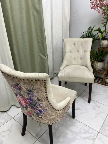 Pair of upholstered floral dining chairs in cream velvet
