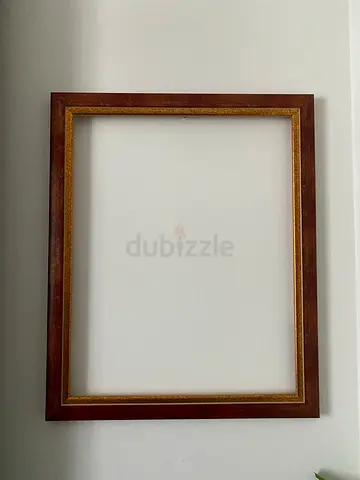 Wooden picture frame with gilt inner trim — good condition