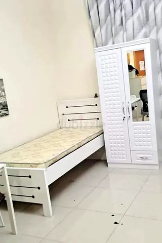Single bed frame with mattress and matching white wardrobe