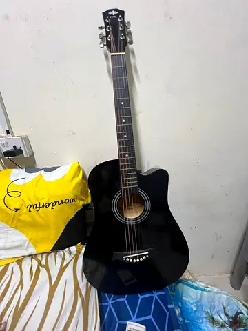 Black acoustic guitar in good condition