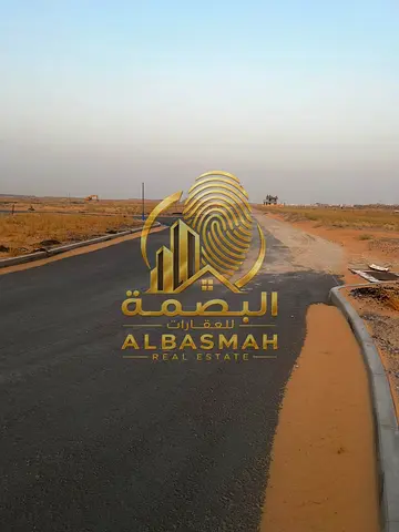 Commercial land for sale on a 36-meter-wide street in Sharjah.