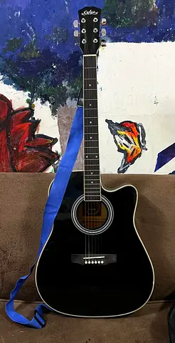 Used black Cort cutaway acoustic guitar with strap & and bag