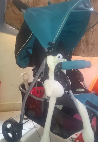 Lightweight teal baby stroller with sun canopy and storage basket