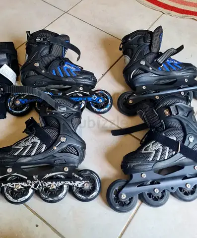 2 Pairs of adjustable inline roller skates - good used condition and protective gears.