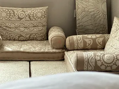 Beige patterned Arabic-style Majlis seating cushions and bolsters - good condition