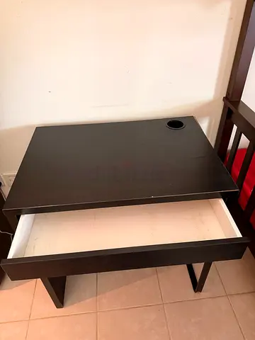 Compact black computer desk with drawer and cable hole