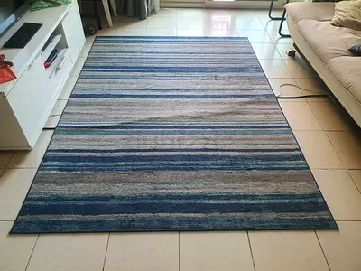 Contemporary rug / carpet with horizontal multi-tone blue, grey, and beige stripes.