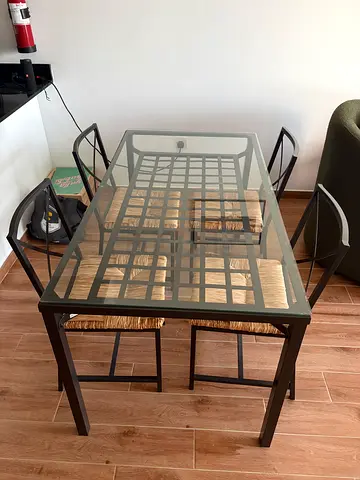 Glass top dining table with 4 woven-seat chairs - good condition
