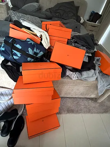 Multiple designer orange boxes (Hermès-style) — lot of shoe/box packaging