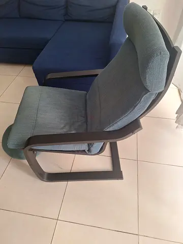 Light blue upholstered reclining armchair with wooden frame