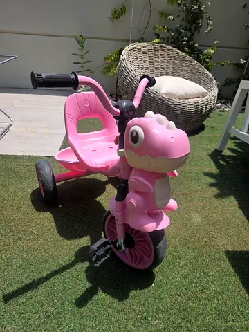 Pink toddler tricycle with dinosaur front - excellent condition