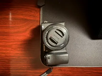 Sony a6300 compact digital camera (small mirrorless-style point-and-shoot) with 30mm lens cap