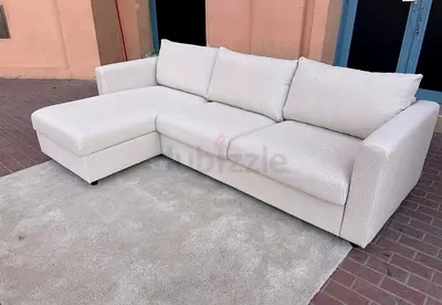 Light beige L-shaped seater sofa bed with chaise longue