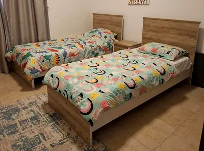 Pair of Single Beds with Matching Headboards and Nightstand - Light Wood Finish